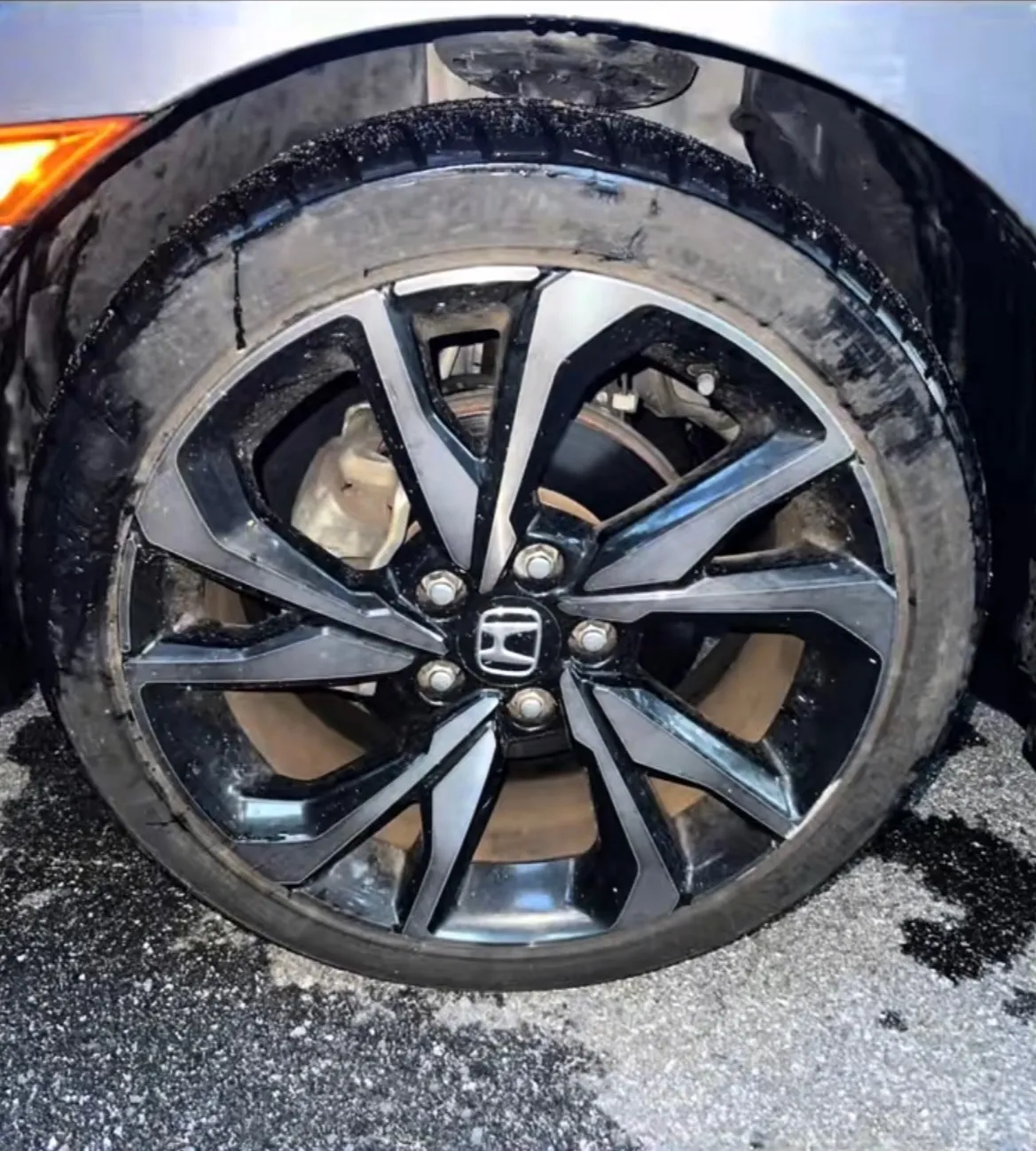 Honda Civic alloy wheel with grime and salt residue before cleaning
