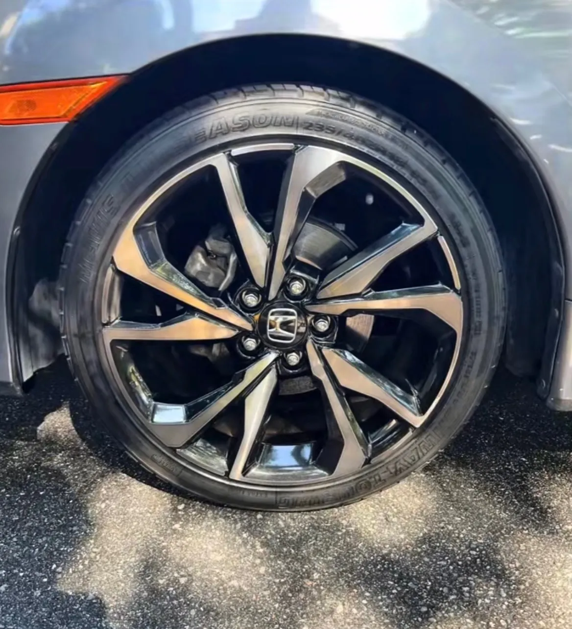 Honda Civic alloy wheel cleaned with freshly dressed tire after detailing